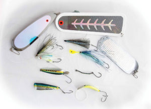 An array of lures and tube flies paired with the right dodger or flasher will often out produce bait as you can keep your gear in the water longer. Below, using oil-based scents stay on lures such as the Wiggle Hootchie, and water soluble scents disperse better in the water.